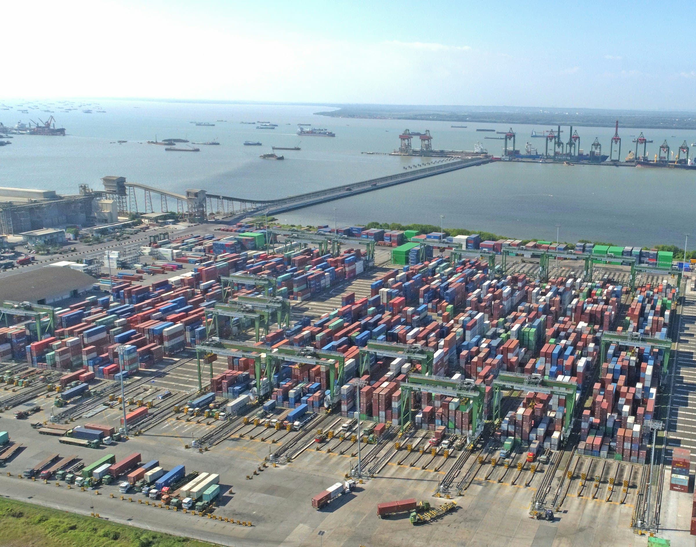 Aerial view of a busy shipping port with stacked containers